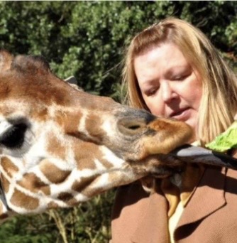 Nadine sharing a close encounter with a giraffe